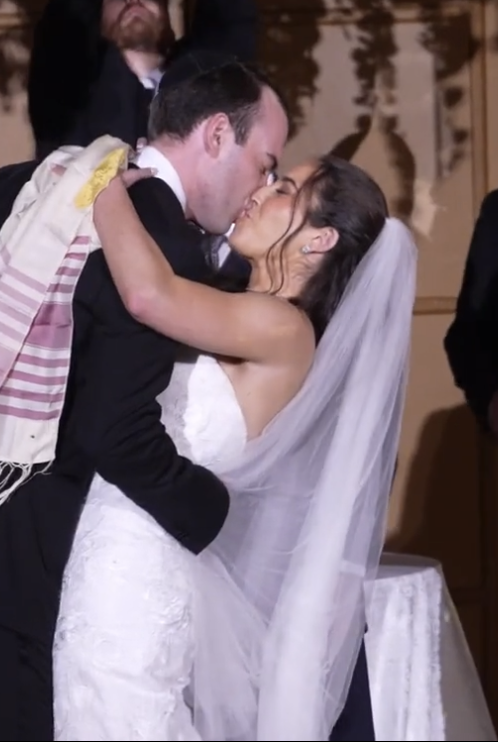 Bride and Groom Kissing and groom dips the bride at end of a Jewish wedding ceremony.